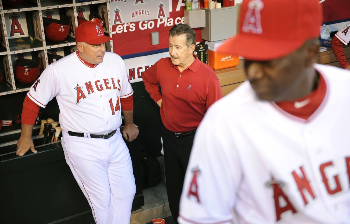 Angels Manager Mike Scioscia and owner Arte Moreno chat before a game in 2013.