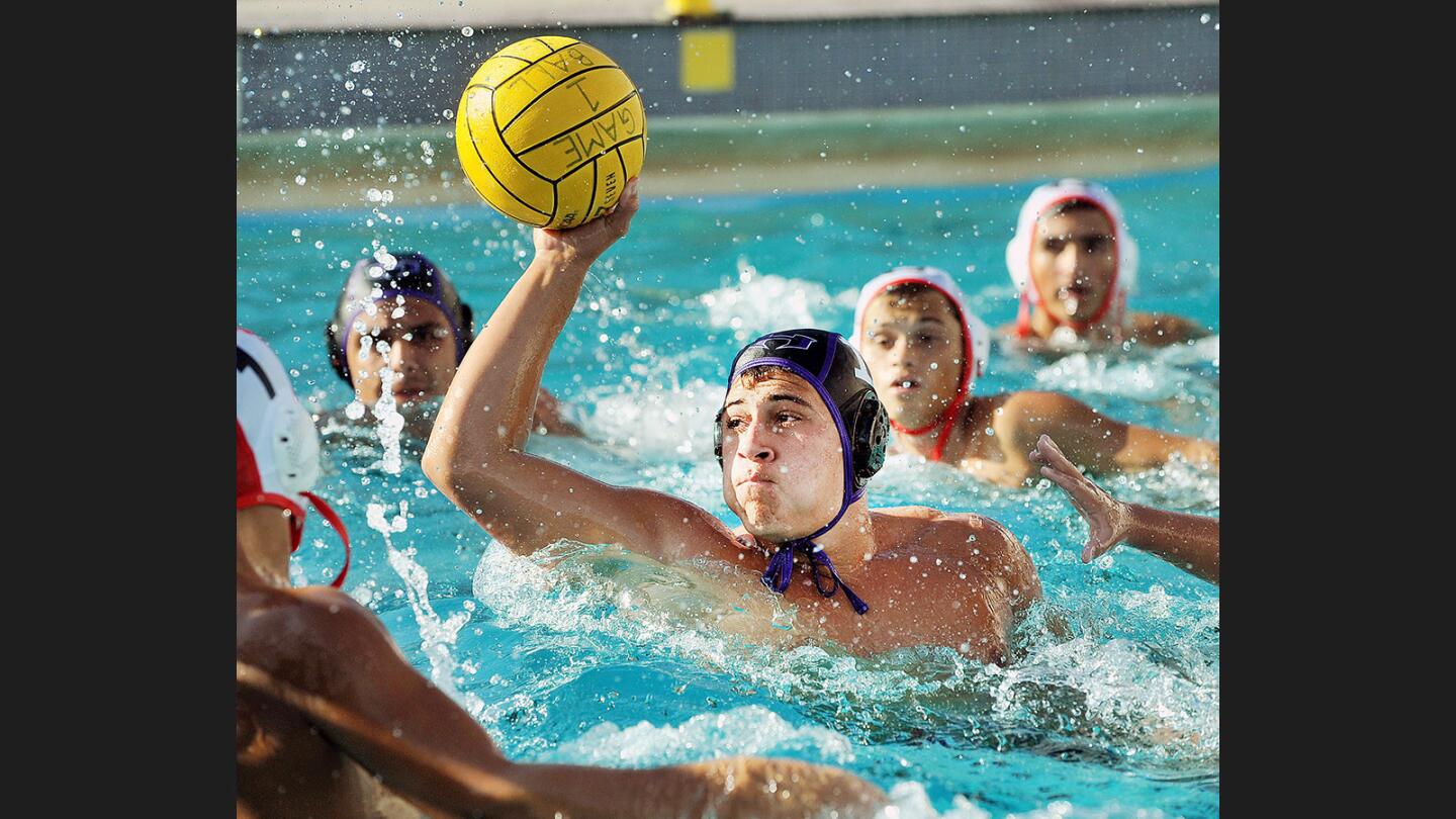 Hoover's Jordan Corpuz shoots right in front of the net against Glendale in a Pacific League boys' water polo match at Hoover High School on Wednesday, October 26, 2016.