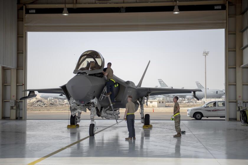 A U.S. fighter pilot and crew members prepare an F-35 for a mission in the United Arab Emirates in 2019.
