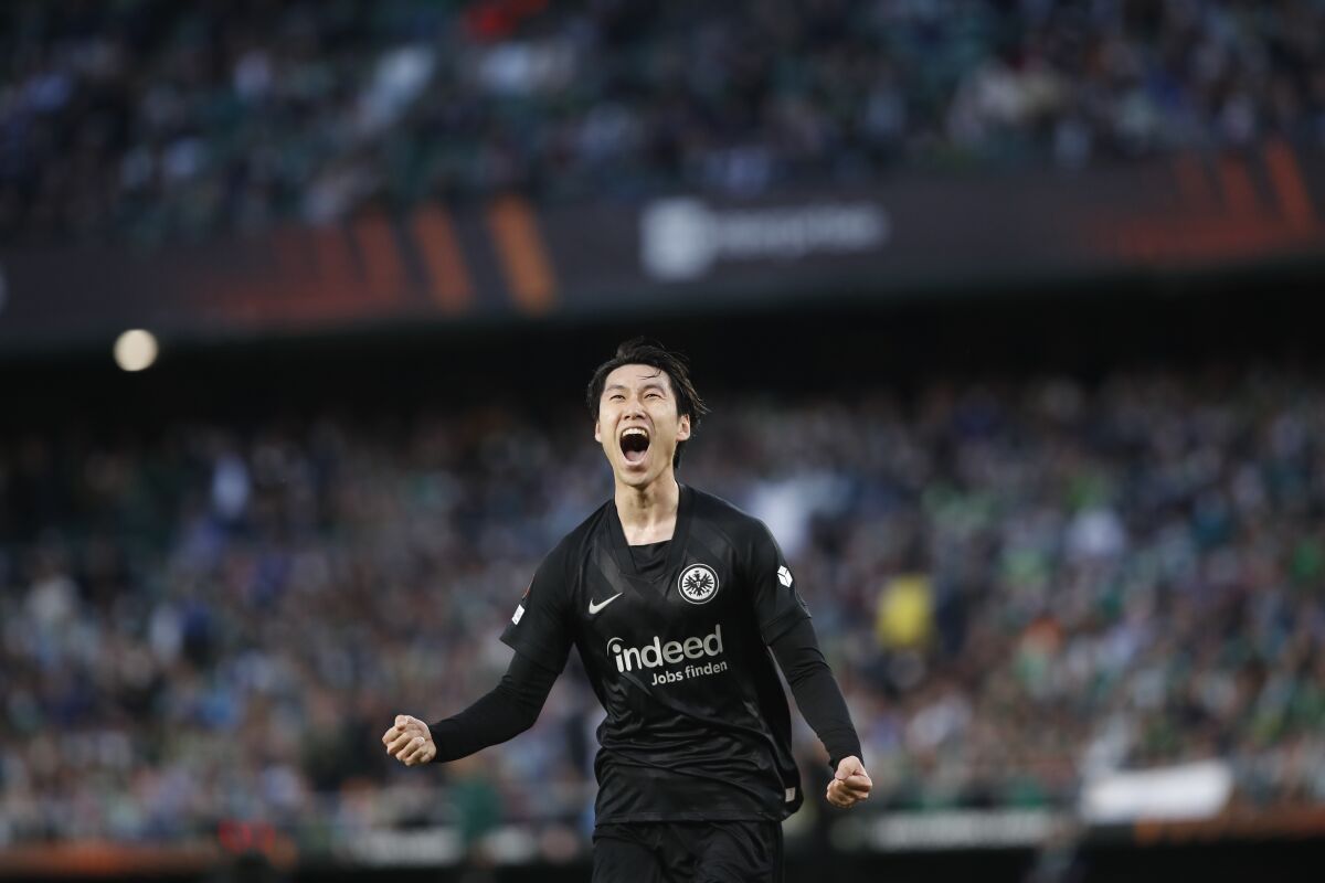 Frankfurt's Daichi Kamada celebrates after scoring his side's second goal during the Europa League, round of 16, first leg soccer match between Betis and Eintracht Frankfurt at the Benito Villamarin stadium in Seville, Spain, Wednesday, March 9, 2022. (AP Photo/Angel Fernandez)