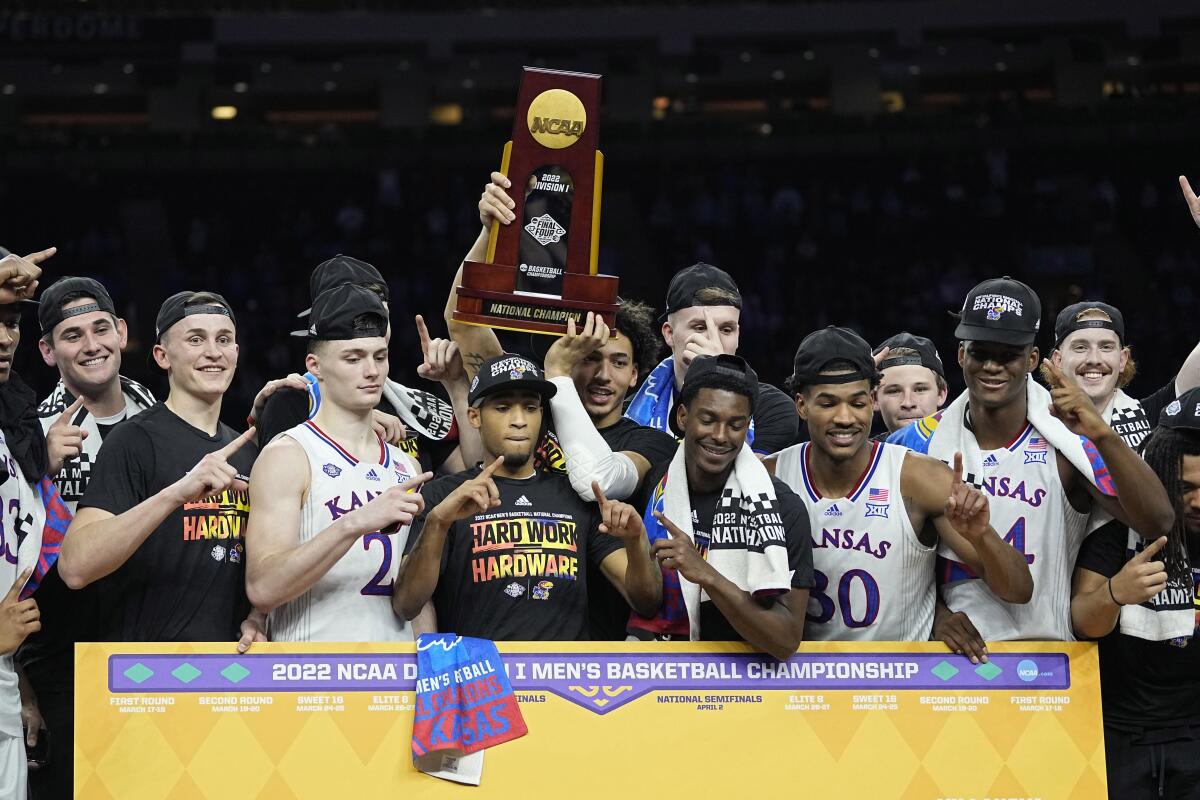 Kansas celebrates with the trophy after their win against North Carolina.