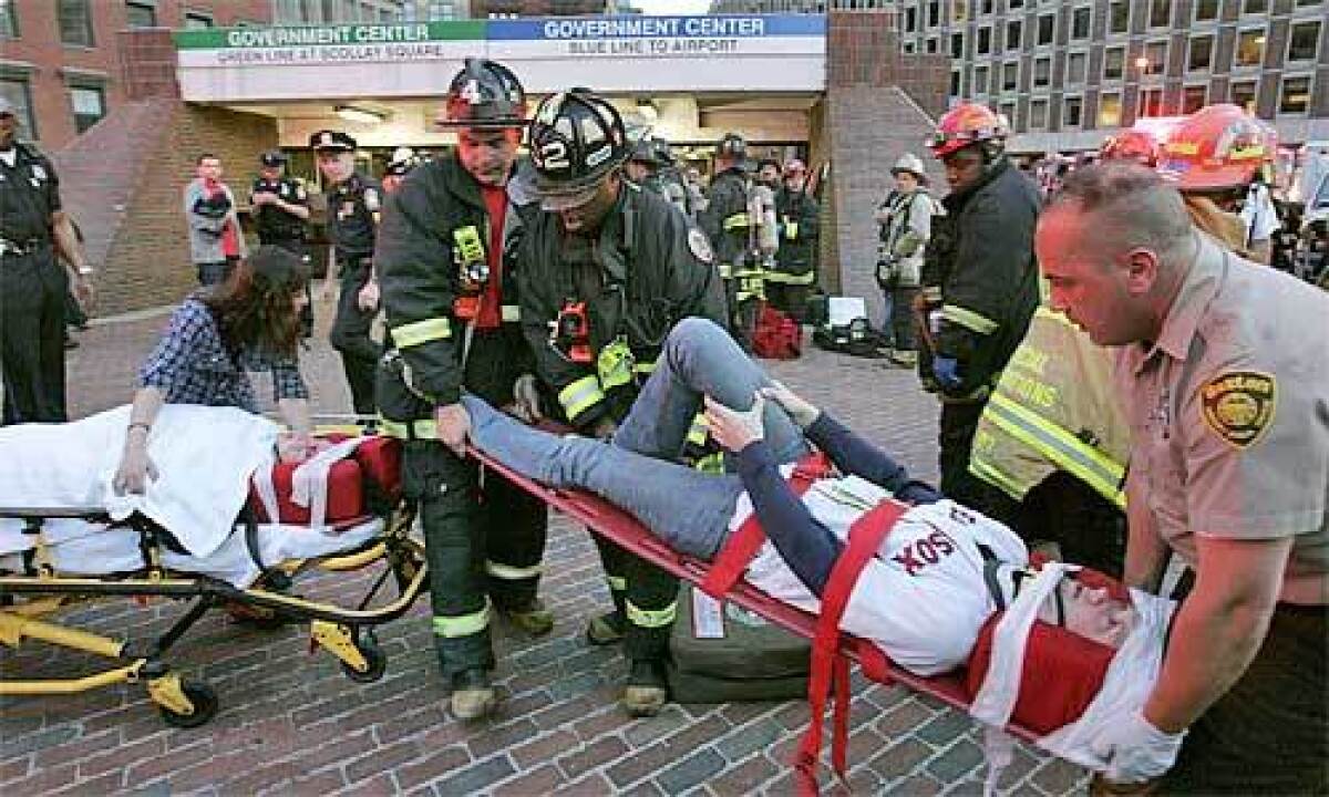 Boston Fire and EMS move an unidentified injured woman from the Government Center station.