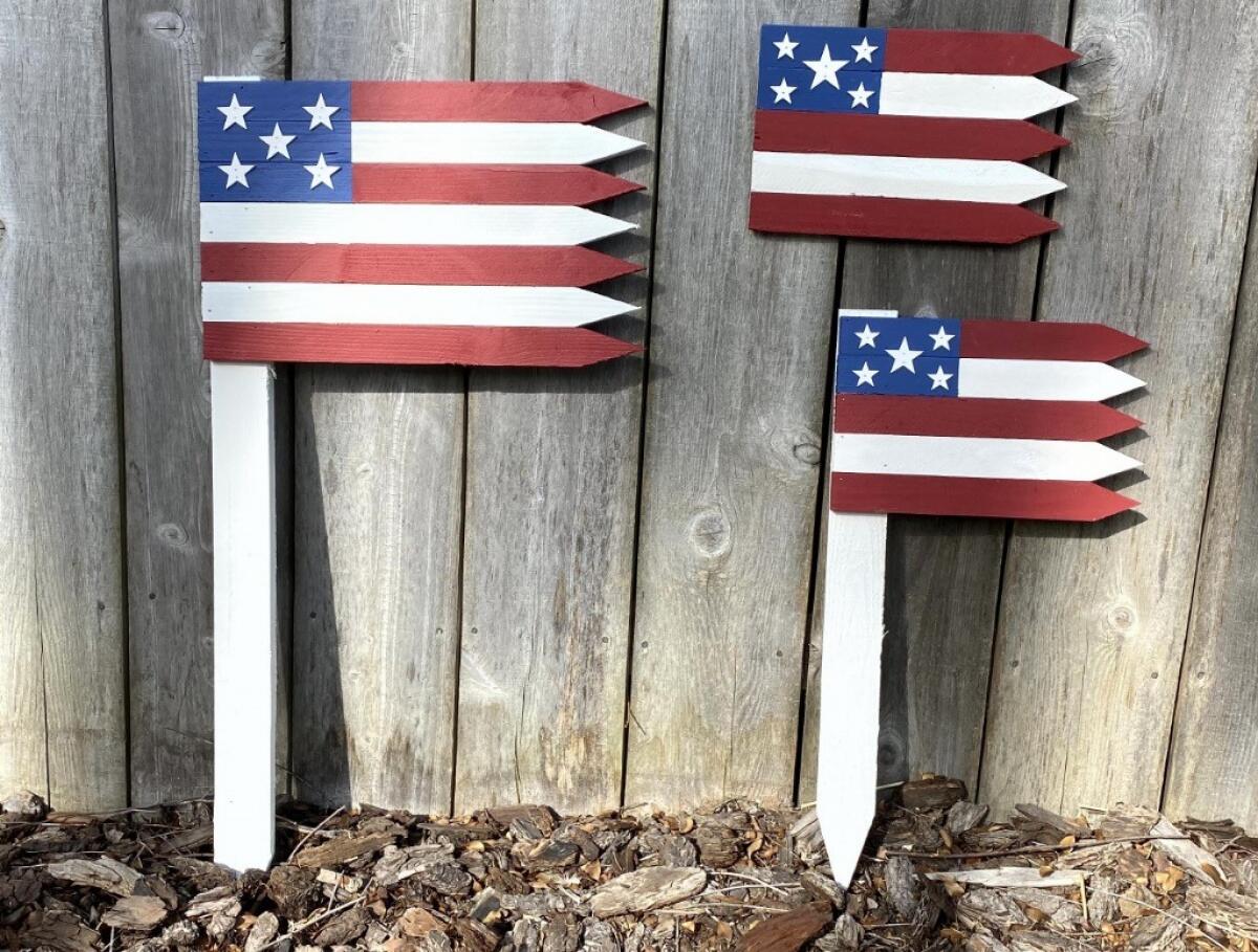 Some of the proceeds from wooden flags like these made by three Point Loma brothers benefit the Wounded Warrior Project.