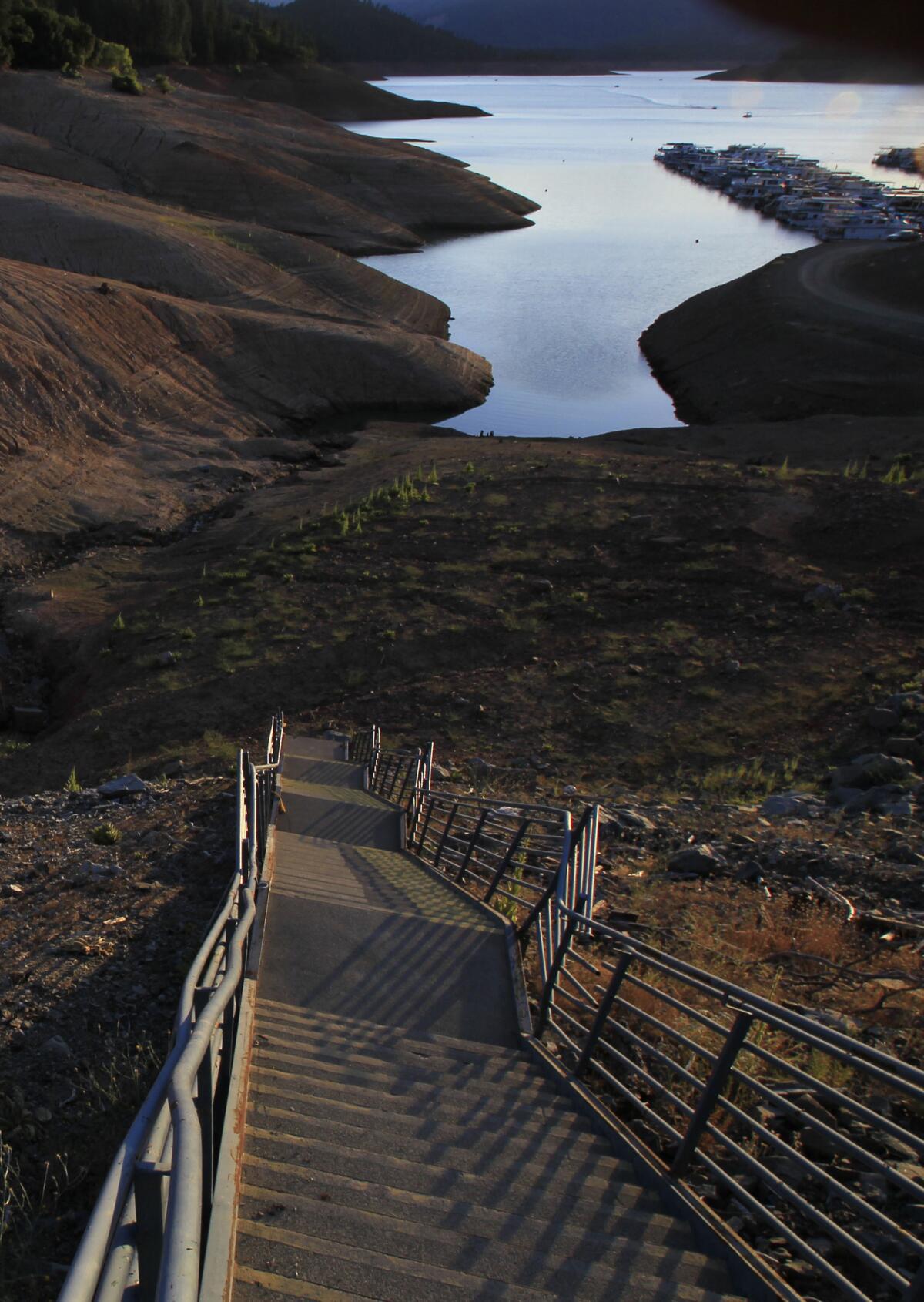 A long staircase leads to a dry lake bed as water recedes into Lake Shasta at sunset due to serious drought conditions. State lawmakers Wednesday approved a ballot measure for a $7.5 billion water bond that includes money for new reservoirs.