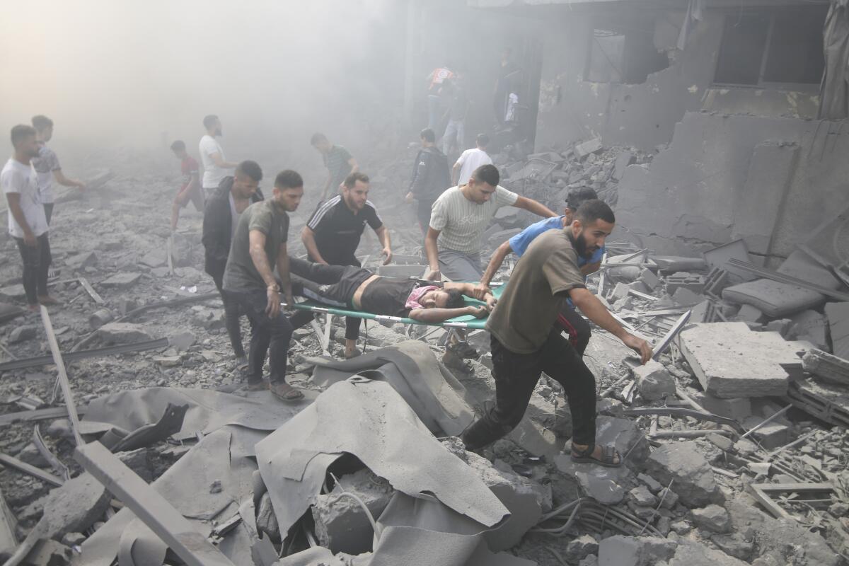 Palestinians evacuate the wounded after an Israeli airstrike in Rafah refugee camp in the southern Gaza Strip.