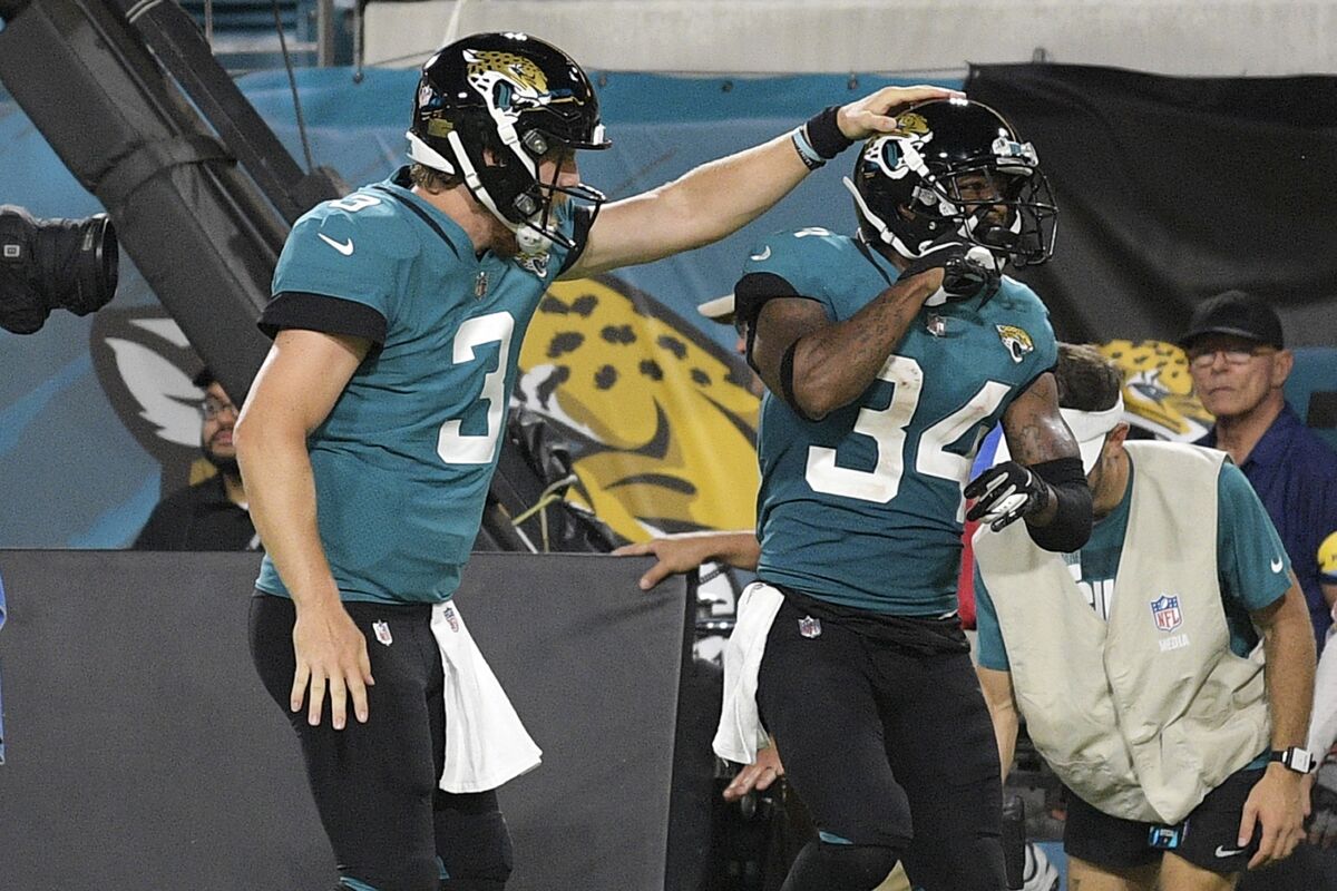 Jacksonville Jaguars quarterback C.J. Beathard (3) congratulates wide receiver Tavon Austin (34) after a reception for a touchdown against the Cleveland Browns during the second half of an NFL preseason football game Saturday, Aug. 14, 2021, in Jacksonville, Fla. (AP Photo/Phelan M. Ebenhack)
