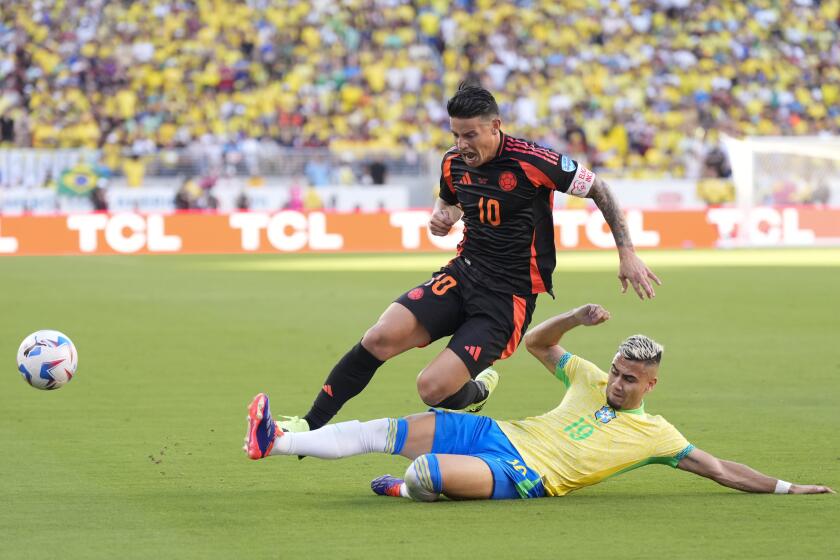 Colombia's James Rodriguez is tackled by Brazil's Andreas Pereira during a Copa America Group D soccer match in Santa Clara, Calif., Tuesday, July 2, 2024. (AP Photo/Tony Avelar)