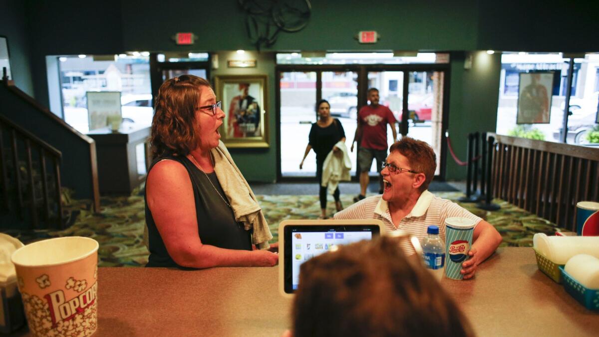 WEBSTER CITY, IA, AUGUST 18, 2018: Linda Hunger (left) of Webster City and Anita Klinger (right) of Webster joke around as they order drinks at the concession stand at the Webster Theater in Webster City, Iowa Saturday, Aug. 18, 2018. Community members rallied around the theater to save it after it closed in 2013. (Rebecca F. Miller / For The Times)