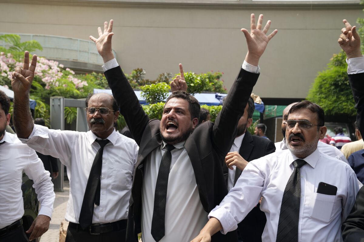 Lawyers and supporters of Pakistan's former Prime Minister Imran Khan chant slogans against the court decision at his residence, in Lahore, Pakistan, Saturday, Aug. 5, 2023. Pakistani police on Saturday arrested former Prime Minister Khan at his home in the eastern city of Lahore. Its the second time the popular opposition leader has been detained this year.(AP Photo/K.M. Chaudary)