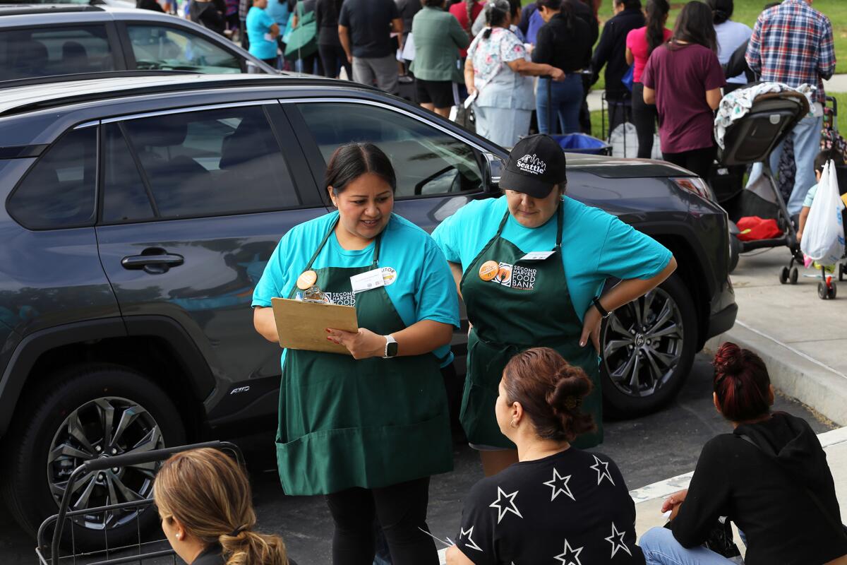 Volunteers help guests as part of the Second Harvest Food Bank's Mobile School Pantry Program at Oak View Elementary School.