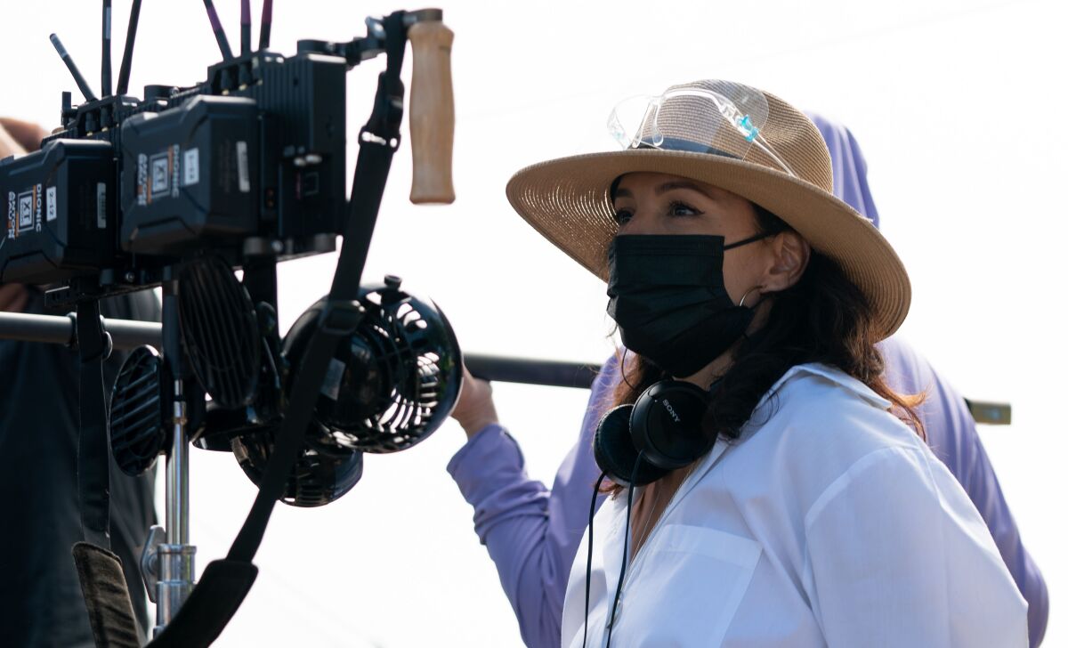 A woman in front of the director's camera.