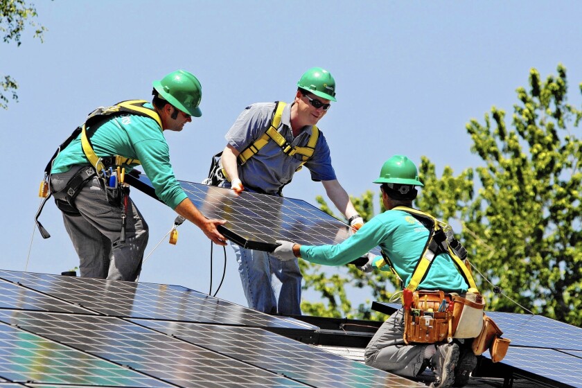 Sen. Michael Bennet (D-Colo.), center, helps as SolarCity employees Jarret Esposito, left, and Jake Torwatzky install rooftop solar panels on a south Denver home in 2010. San Mateo, Calif.-based SolarCity operates in 19 states.