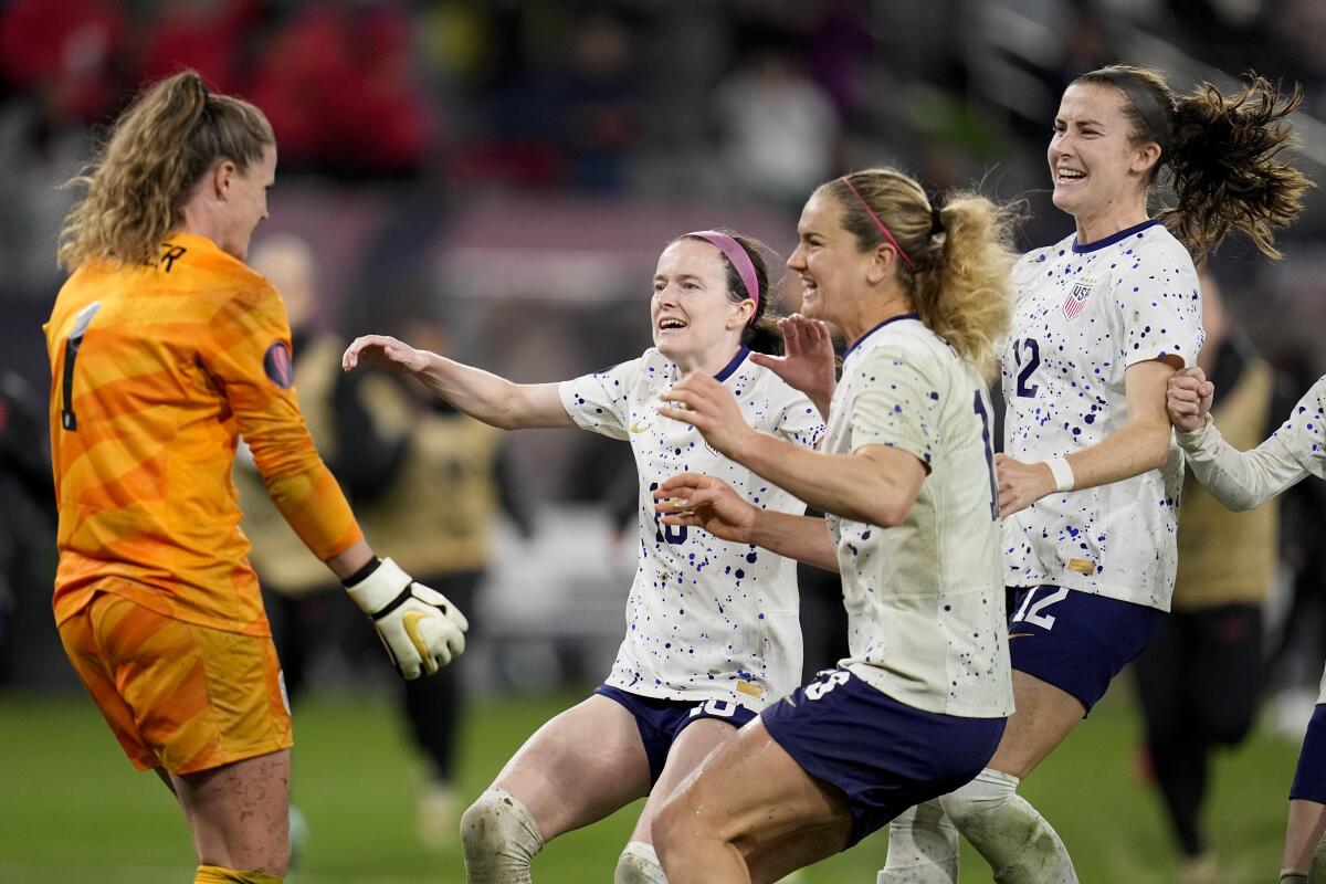 U.S. goalkeeper Alyssa Naeher celebrates with teammates at the end of a penalty shootout 