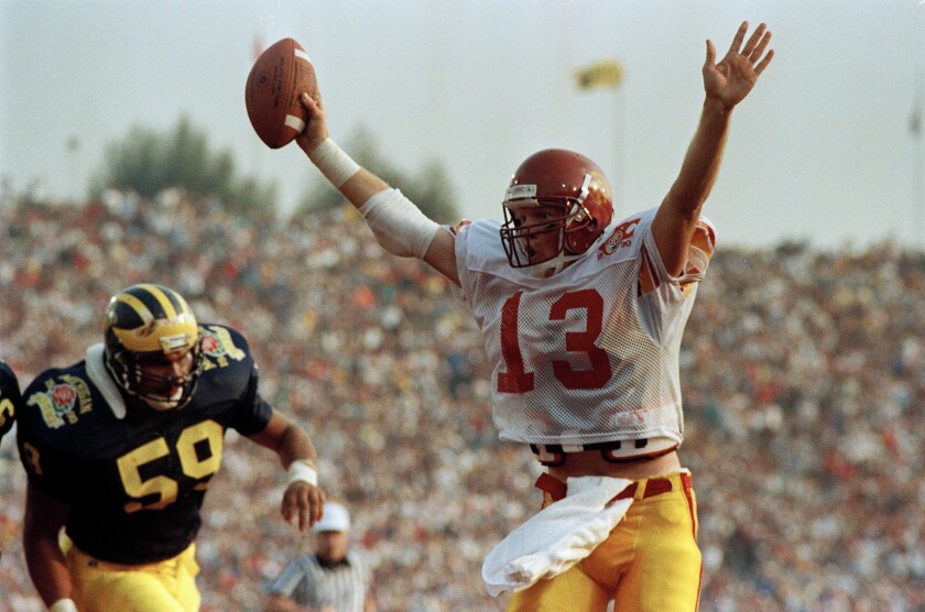 USC quarterback Todd Marinovich celebrates as he scores a touchdown against Michigan.