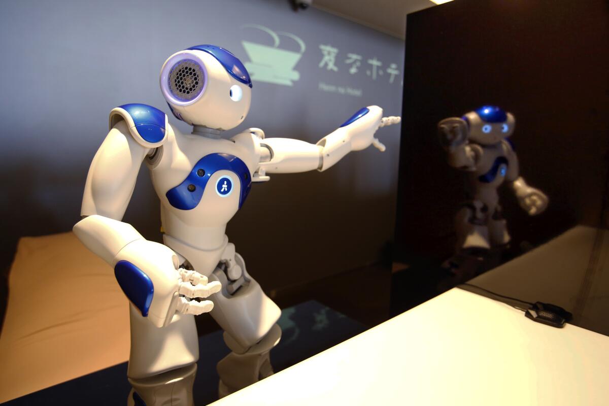 A receptionist robot performs during a demonstration for the media at the new hotel, aptly called Henn na Hotel or Weird Hotel, in Sasebo, southwestern Japan, Wednesday, July 15, 2015. From the receptionist that does the check-in and check-out to the porter that's a stand-on-wheels taking luggage up to the room, the hotel, that is run as part of Huis Ten Bosch amusement park, is "manned" almost totally by robots to save labor costs. (AP Photo/Shizuo Kambayashi)
