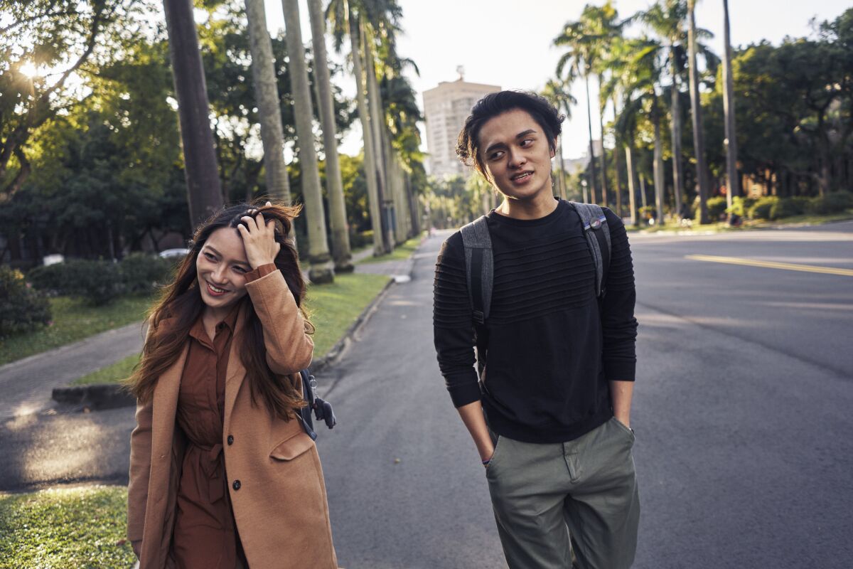Shayne Mei, son of Mei Heng-han, walks with his girlfriend, Daphne Chiu, at National Taiwan University in Taipei.