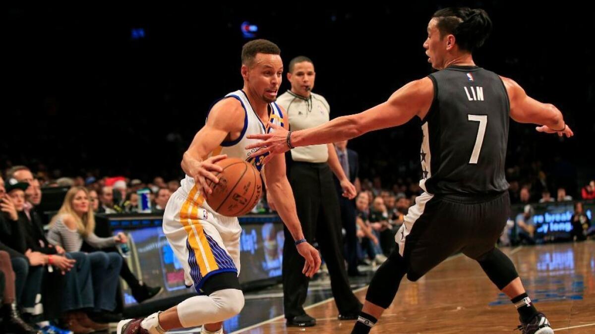 Golden State Warriors guard Stephen Curry drives to the basket past Brooklyn Nets guard Jeremy Lin during the second half of a game on Dec. 22.