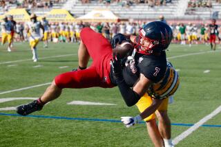 Palos Verdes receiver Luke Layton catches the ball in midair as he gets hit by Edison cornerback Jared Schnoor in the first half.