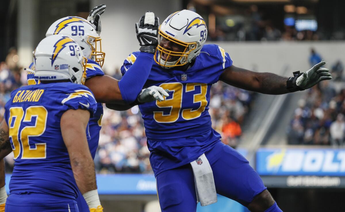 Chargers defensive tackle Justin Jones celebrates after stopping New York Giants running back Saquon Barkley.