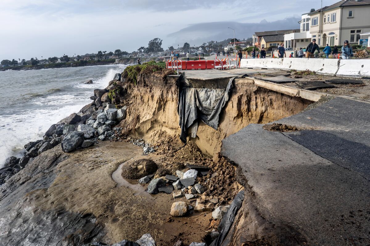 A road in Santa Cruz is partly washed into the ocean.