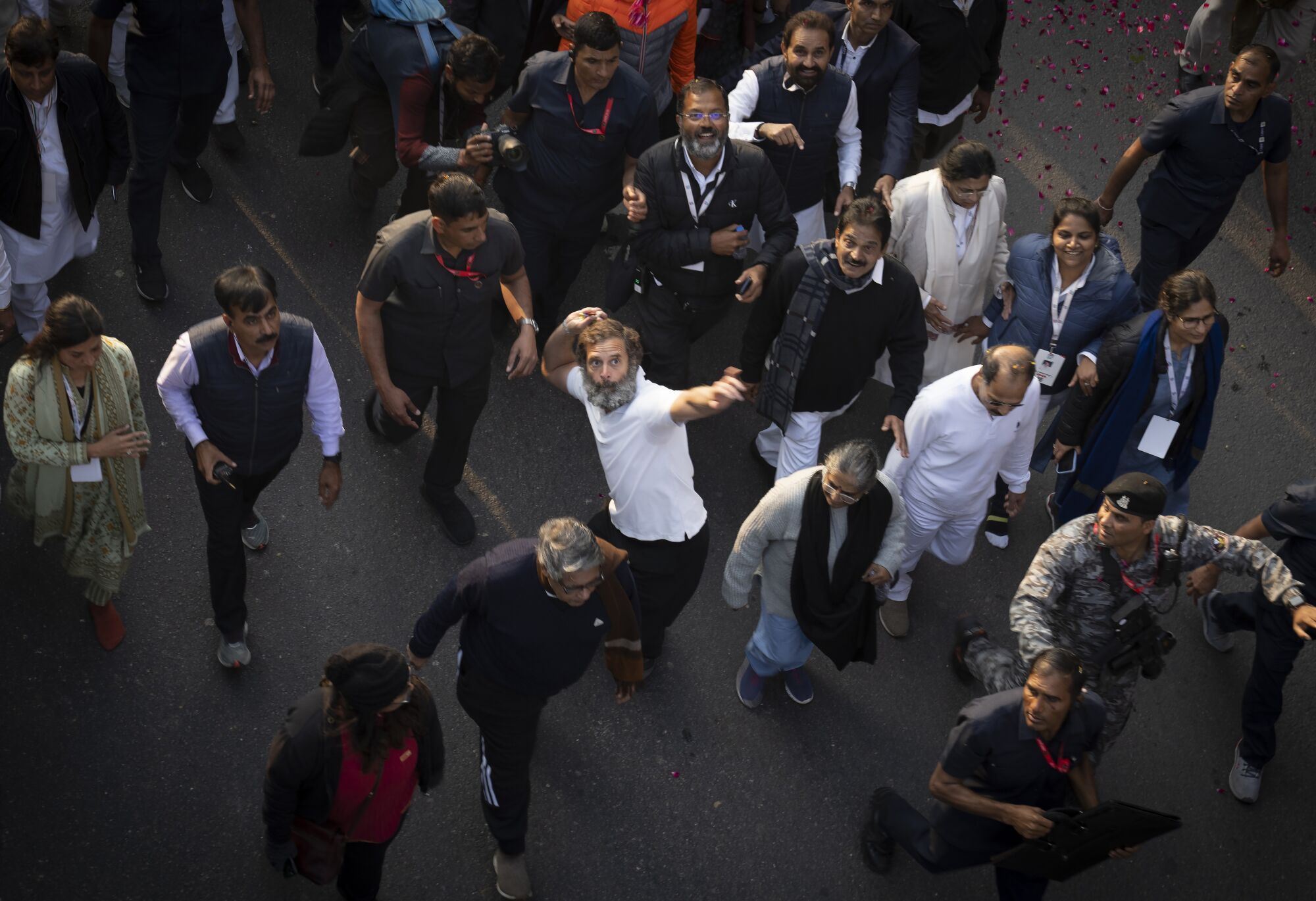 Rahul Gandhi, leader of India's opposition Congress party, centre in white T-shirt, throws flower petals 