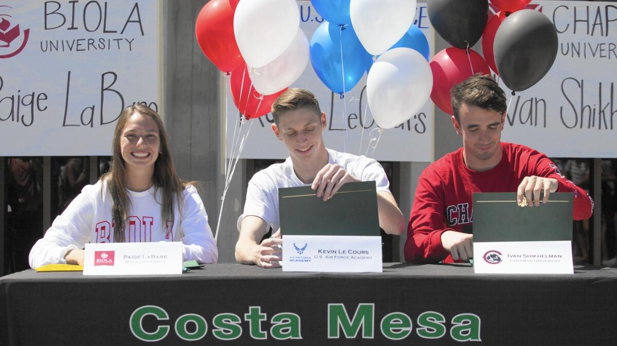 Costa Mesa High student-athletes, from left, Paige LaBare, Kevin LeCours and Ivan Shikhelman sign their college letter of intent on Tuesday.