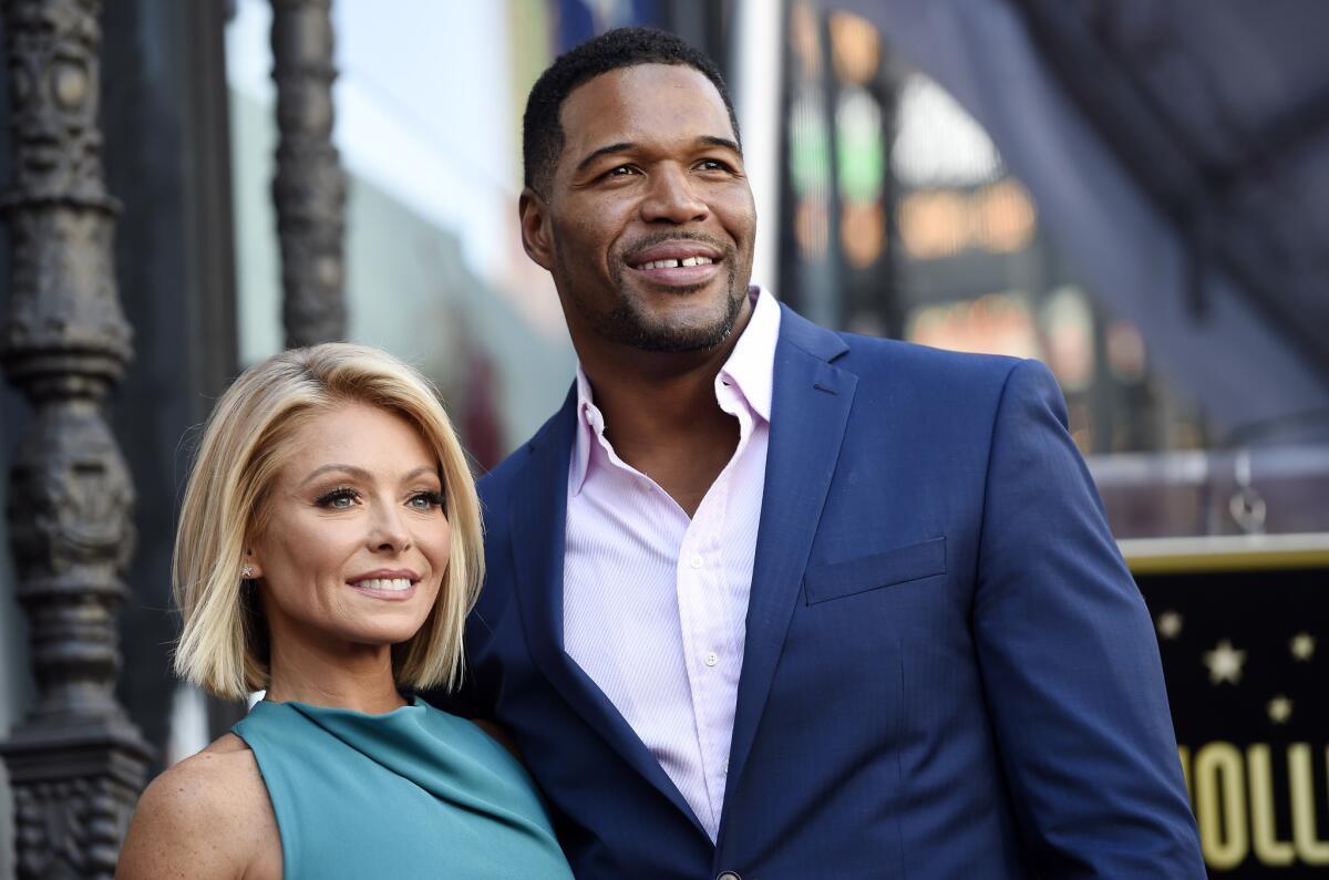 Kelly Ripa and Michael Strahan pose during an October 2015 ceremony honoring Ripa with a star on the Hollywood Walk of Fame in Los Angeles.