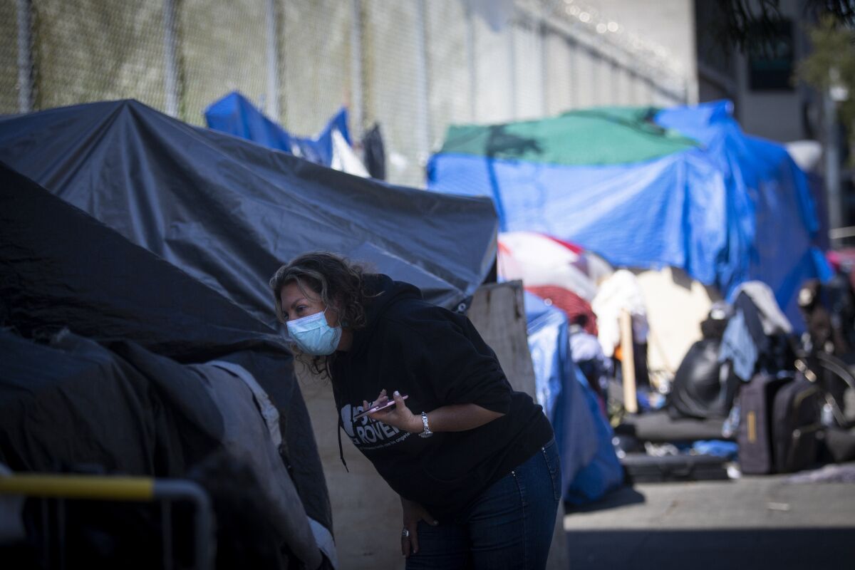 Dr. Susan Partovi searches an encampment for people who may be experiencing symptoms of the coronavirus. “Is anyone around here sick?” she asked.