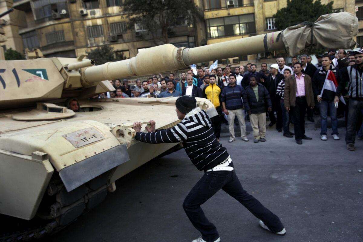 A lone protester steps into the path of an oncoming tank near Tahrir Square in January 2011.