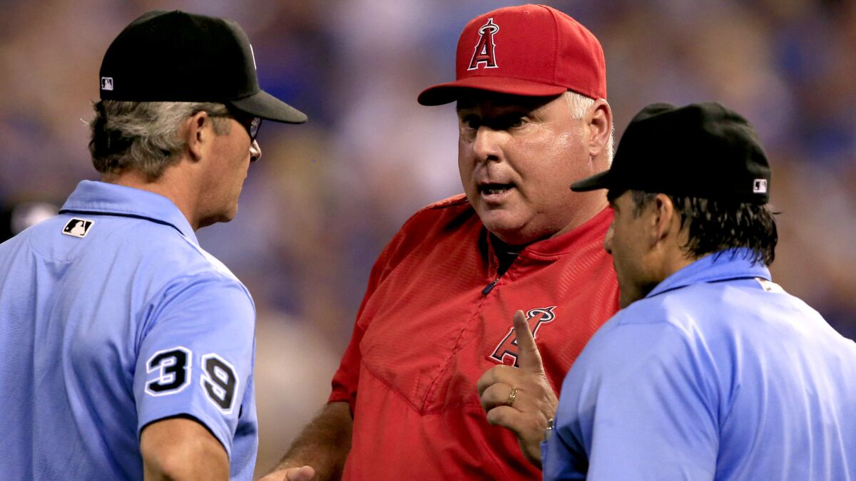 Angels Manager Mike Scioscia argues a call with umpires Paul Nauert (39) and Phil Cuzzi during the a game against the Royals in Kansas City on July 28.