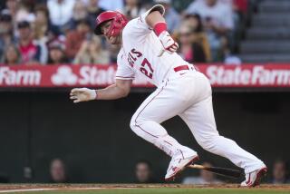 Angels' Mike Trout runs to first base after hitting a single 