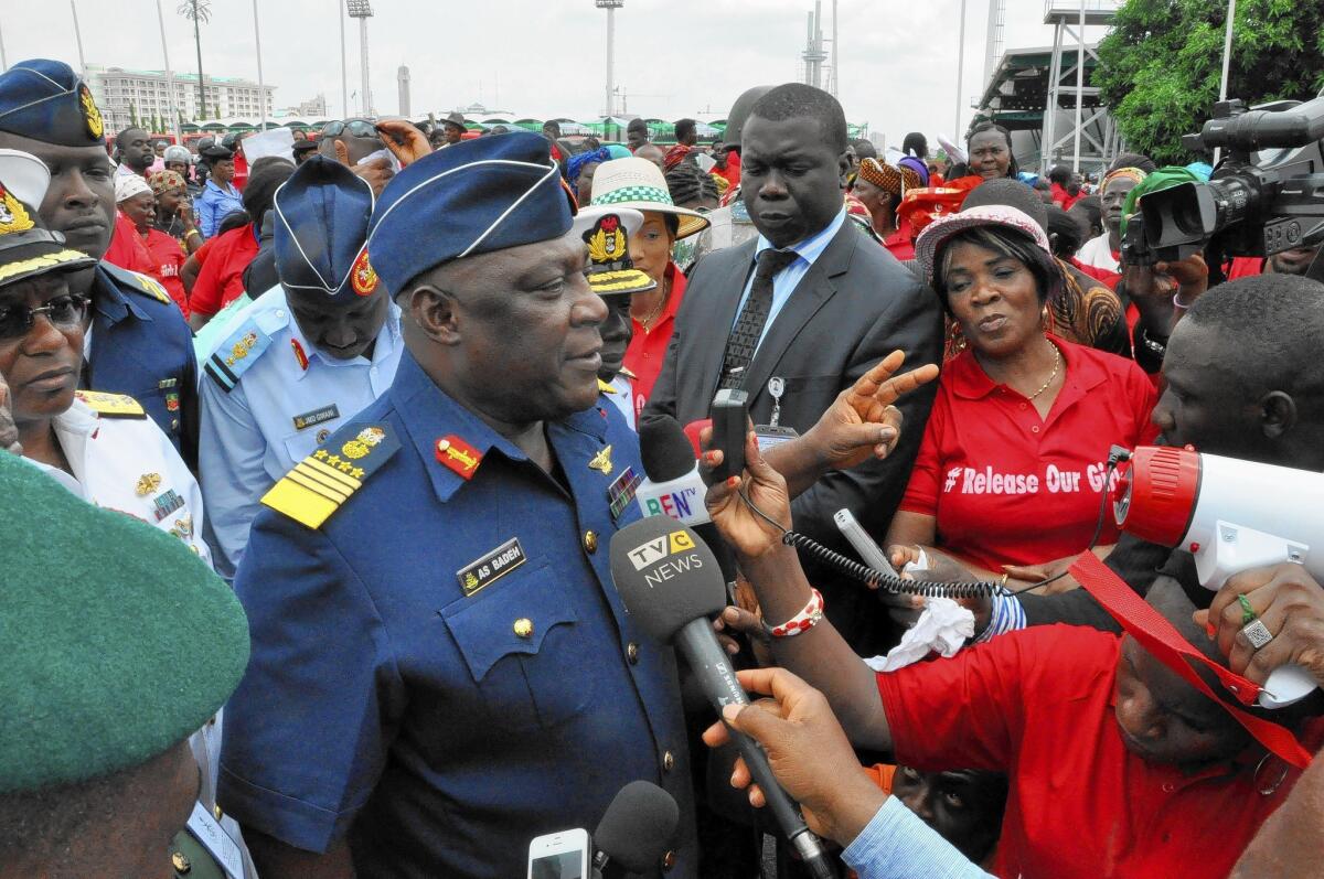 Air Marshal Alex Badeh, center, Nigeria's chief of defense staff, speaks in Abuja during a demonstration calling on the government to rescue the schoolgirls held by the militant group Boko Haram.