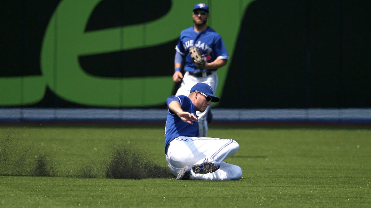 Blue Jays left fielder Michael Saunders slides to make a defensive stop during a game in Toronto against the Boston Red Sox on May 9.