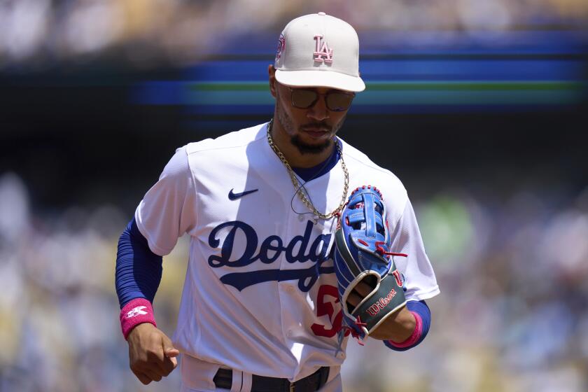 Los Angeles Dodgers' Mookie Betts runs into the dugout during the fourth inning.