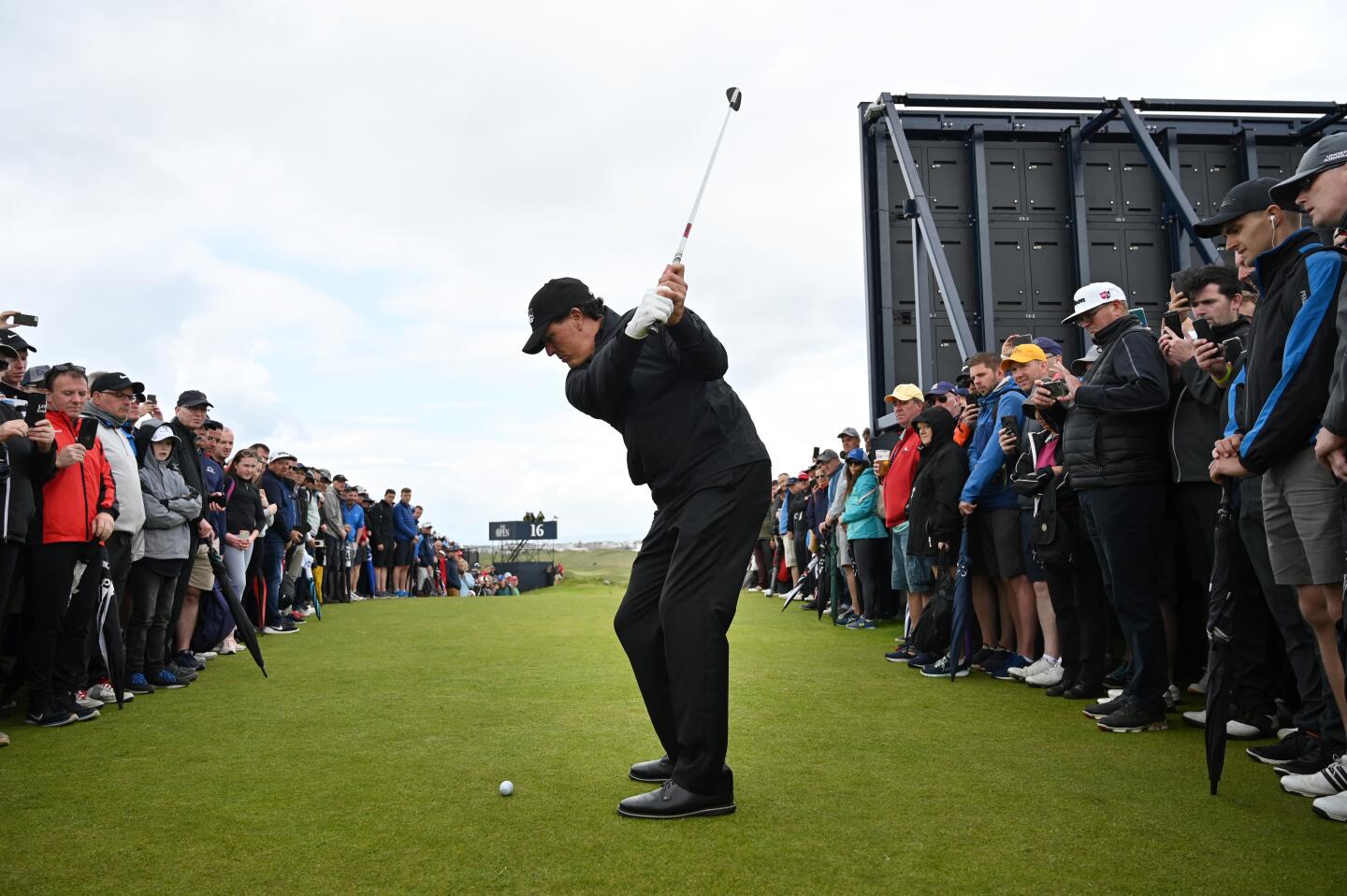 Phil Mickelson plays a shot after missing the green on the 16th hole during the first round of the 148th Open Championship at Royal Portrush Golf Club in Northern Ireland. Mickelson bogeyed the par-three and shot five-over 76.