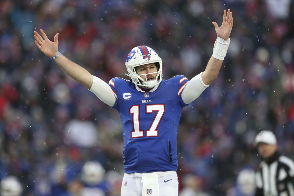 Buffalo Bills quarterback Josh Allen (17) celebrates after Devin Singletary (26) rushed for a touchdown during the second half of an NFL football game against the Atlanta Falcons Sunday, Jan. 2, 2022, in Orchard Park, N.Y. The Bills won 29-15. (AP Photo/Joshua Bessex)