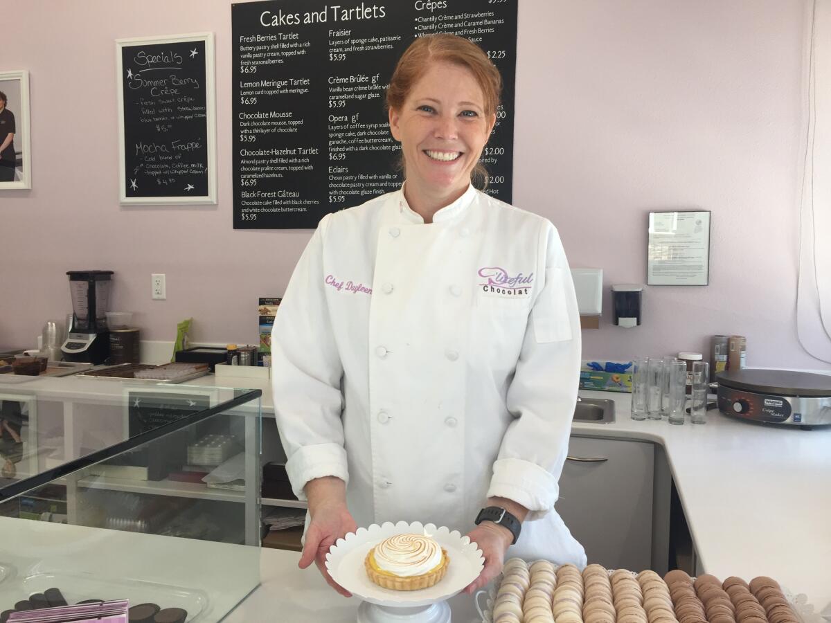 Dayleen Coleman plates up a lemon tart at her newly opened D'Liteful Chocolat Patisserie & Chocolatier shop in Lake San Marcos.