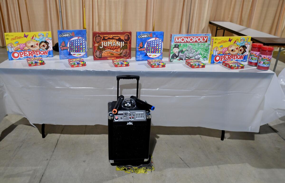 Board games sit on a table near a karaoke machine