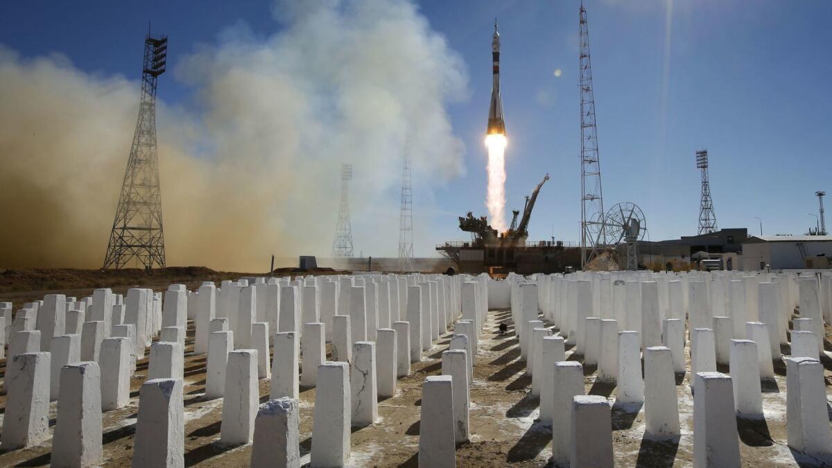 Soyuz booster rocket with the Soyuz spacecraft carrying two crew members — an American and a Russian — takes off at Baikonur, Kazakhstan. The Russian rocket malfunctioned on liftoff but the crew landed safely.