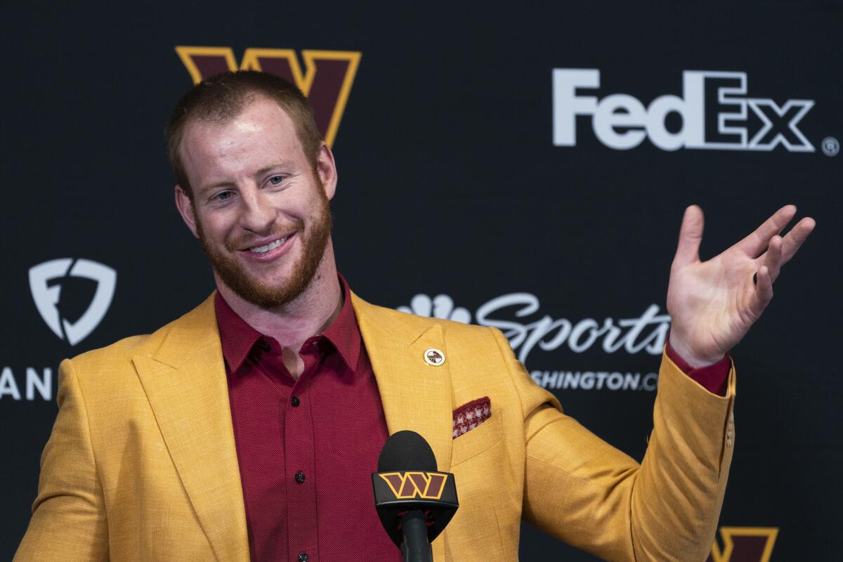 Washington Commanders quarterback Carson Wentz speaks at his introductory news conference in March.