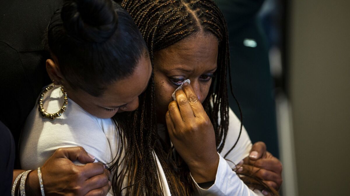 Pride Franklin, left, hugs Cherie Townsend after speaking during a news conference Monday. Townsend was accused of murder after visiting the Promenade on the Peninsula shopping center the same day retired nurse Susan Leeds, 66, was found stabbed in her Mercedes in May.