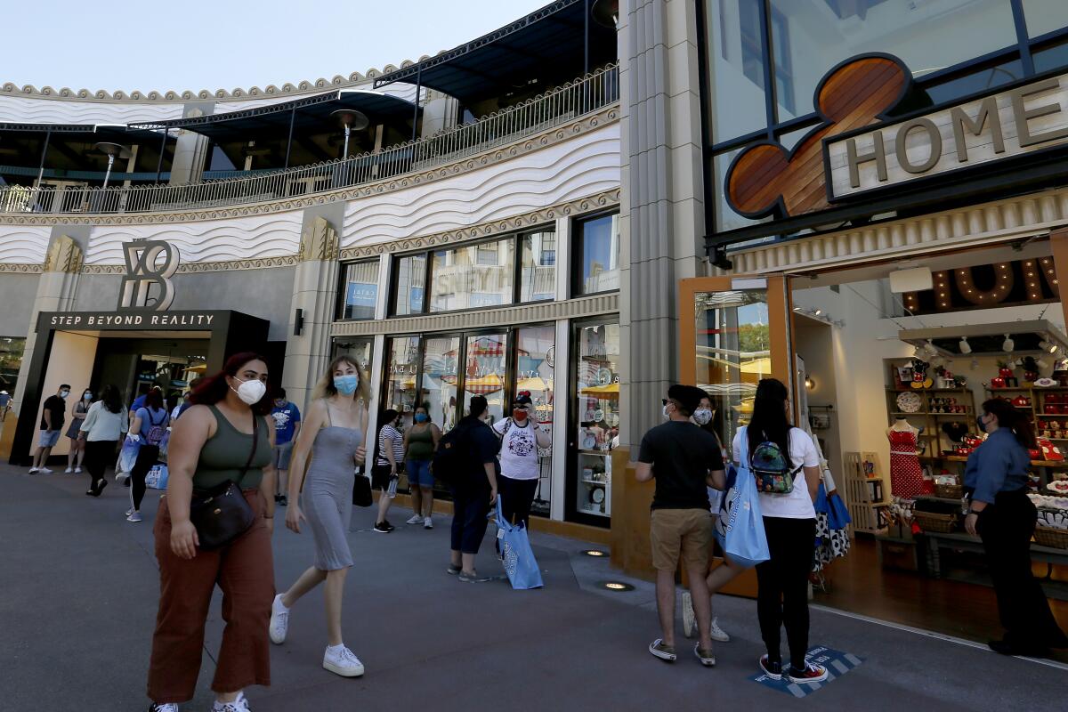 Visitors stroll through Downtown Disney on Thursday, July 9, 2020.