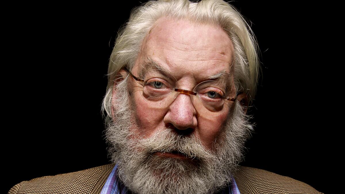 Donald Sutherland looking directly into the camera lens with a bushy beard and moustache