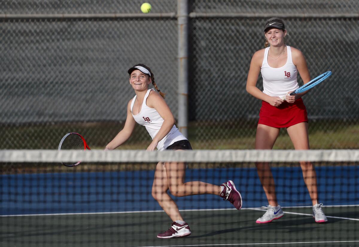 Laguna Beach doubles players Sarah MacCallum, left, and Ella Pachl compete in the CIF Southern Section Individuals tournament round of 16 match on Thursday at Lakewood Tennis Center.