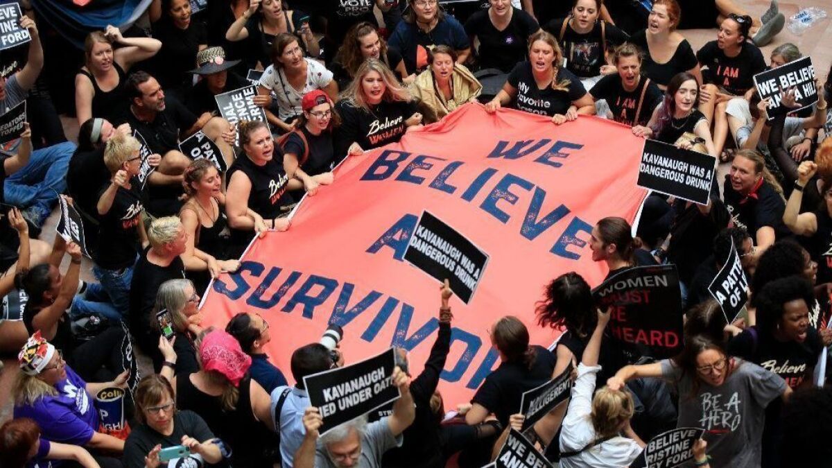 Protesters against Supreme Court nominee Brett Kavanaugh gather in the atrium of the Hart Senate Office Building in Washington, D.C., on Oct. 4.