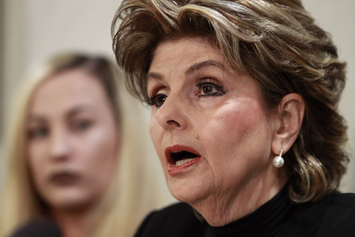 Attorney Gloria Allred, former Marine Erika Butner, active duty Marine Lance Cpl. Marisa Woytek, both victims of the Marines United scandal, hold a news conference at the Holiday Inn Oceanside Marina in Oceanside on Thursday.