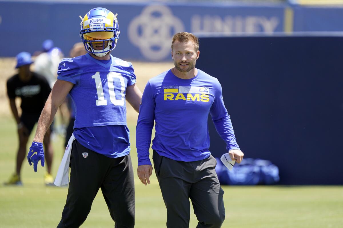 Rams wide receiver Cooper Kupp and coach Sean McVay watch drills Thursday during mandatory minicamp.