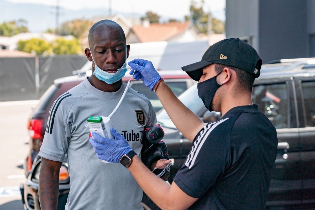 LAFC forward Bradley Wright-Phillips gets his temperature checked before taking part in Thursday's training session.