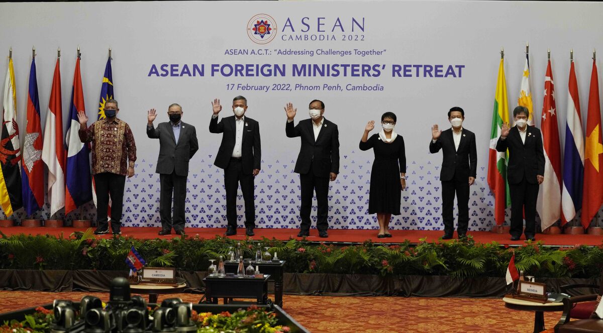 CORRECTS TO IDENTIFY THE FOREIGN MINISTER AT RIGHT AS INDONESIAN, NOT BRUNEIAN - Foreign ministers of the Association of Southeast Asian Nations (ASEAN) pose for a photo during a photo session in Phnom Penh, Cambodia, Thursday, Feb. 17, 2022. From left are Malasian Saifuddin Abdullah, Philippine TTeodoro Locsin Jr, Singaporean Vivian Balakrishnan, Cambodian Prak Sokhonn, Indonesia Foreign Minister Retno Marsudi, Laotian Saleumxay Kommasith and ASEAN Secretary General Lim Jock Hoi. (AP Photo/Heng Sinith)