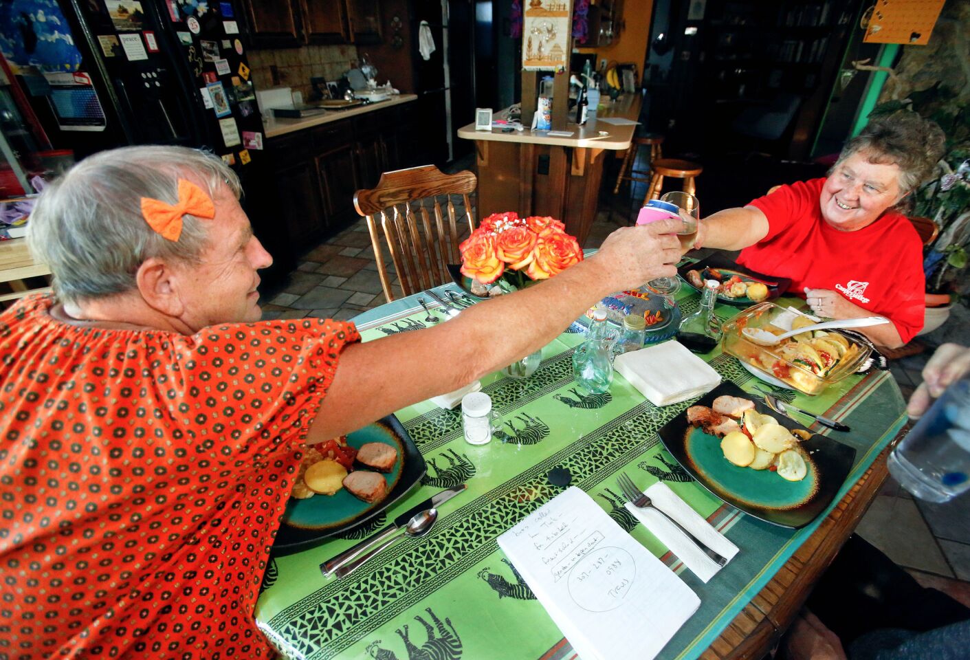 Sissy and Vickie Goodwin click glasses before dinner at home. He credits her with helping him learn to accept himself.